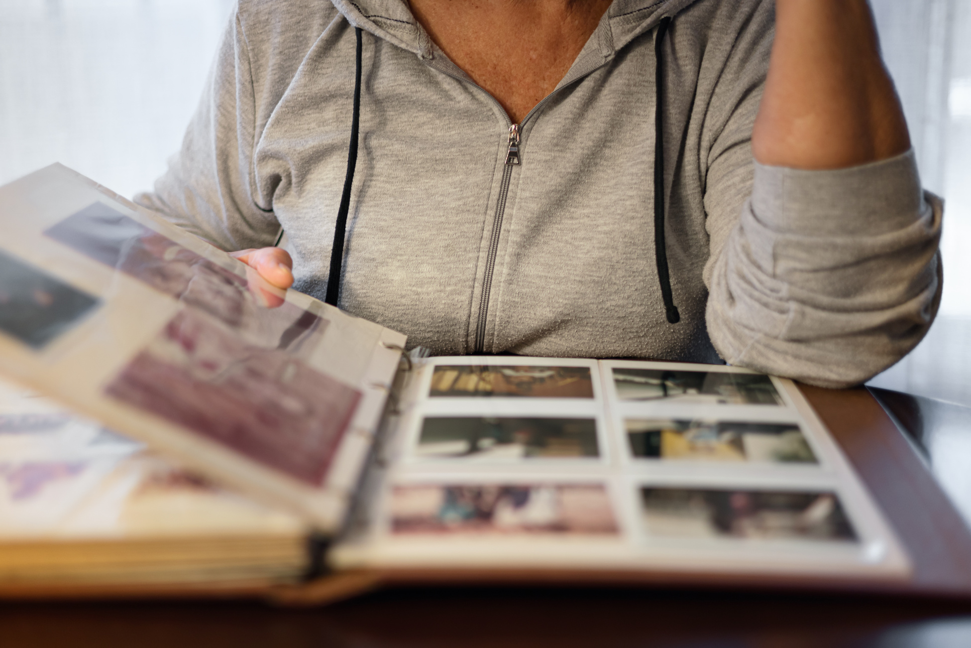 Old woman looking at photo album